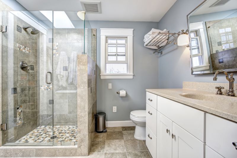 Renovated bathroom with frameless glass enclosure